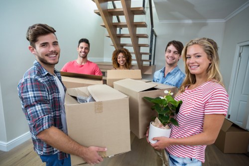 Professional movers transporting boxes during a same day relocation