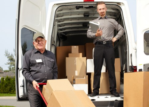 Man with a van loading household items for transport